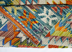 A handwoven Afghan Maimana kilim rug featuring a vibrant geometric pattern in wool.