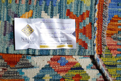 A handwoven Afghan Maimana Kilim featuring vibrant geometric patterns in wool.