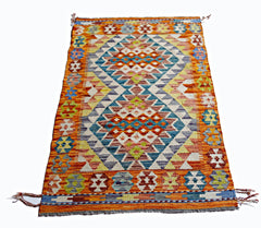 Handwoven Afghan Maimana kilim rug featuring a vibrant geometric pattern in wool.