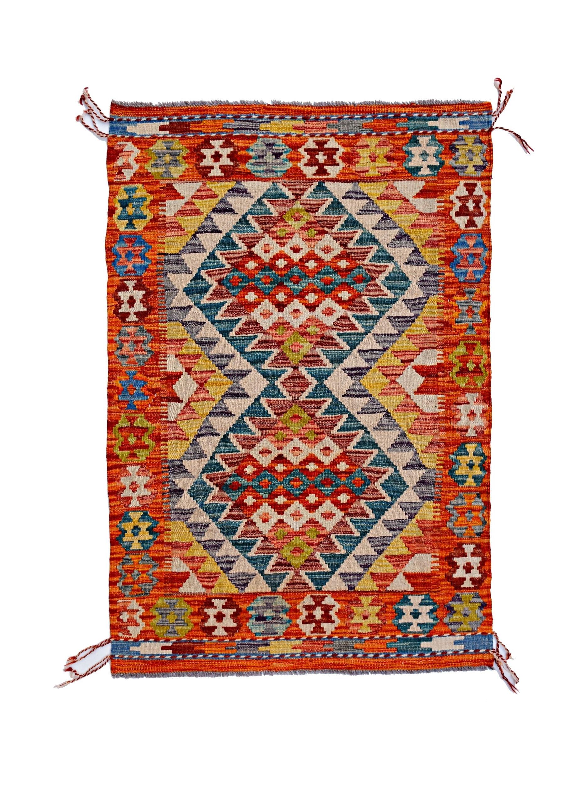 Handwoven Afghan Maimana kilim rug featuring a vibrant geometric pattern in warm, earthy tones.