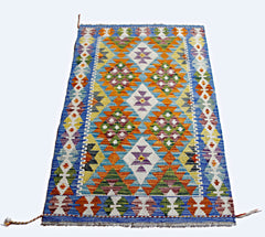 Handwoven Afghan Maimana kilim featuring a vibrant geometric pattern in wool.
