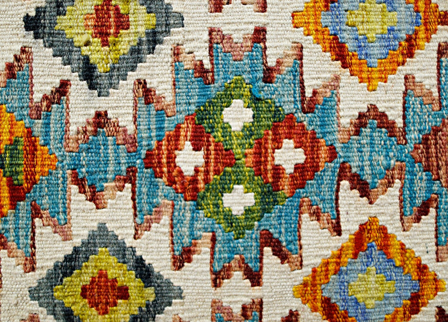Handwoven Afghan Maimana kilim featuring a vibrant geometric pattern in wool.