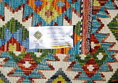 A handwoven Afghan Maimana kilim featuring a vibrant geometric pattern in wool.
