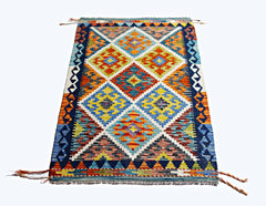 Handwoven Afghan Maimana kilim rug featuring a vibrant geometric diamond pattern in wool.