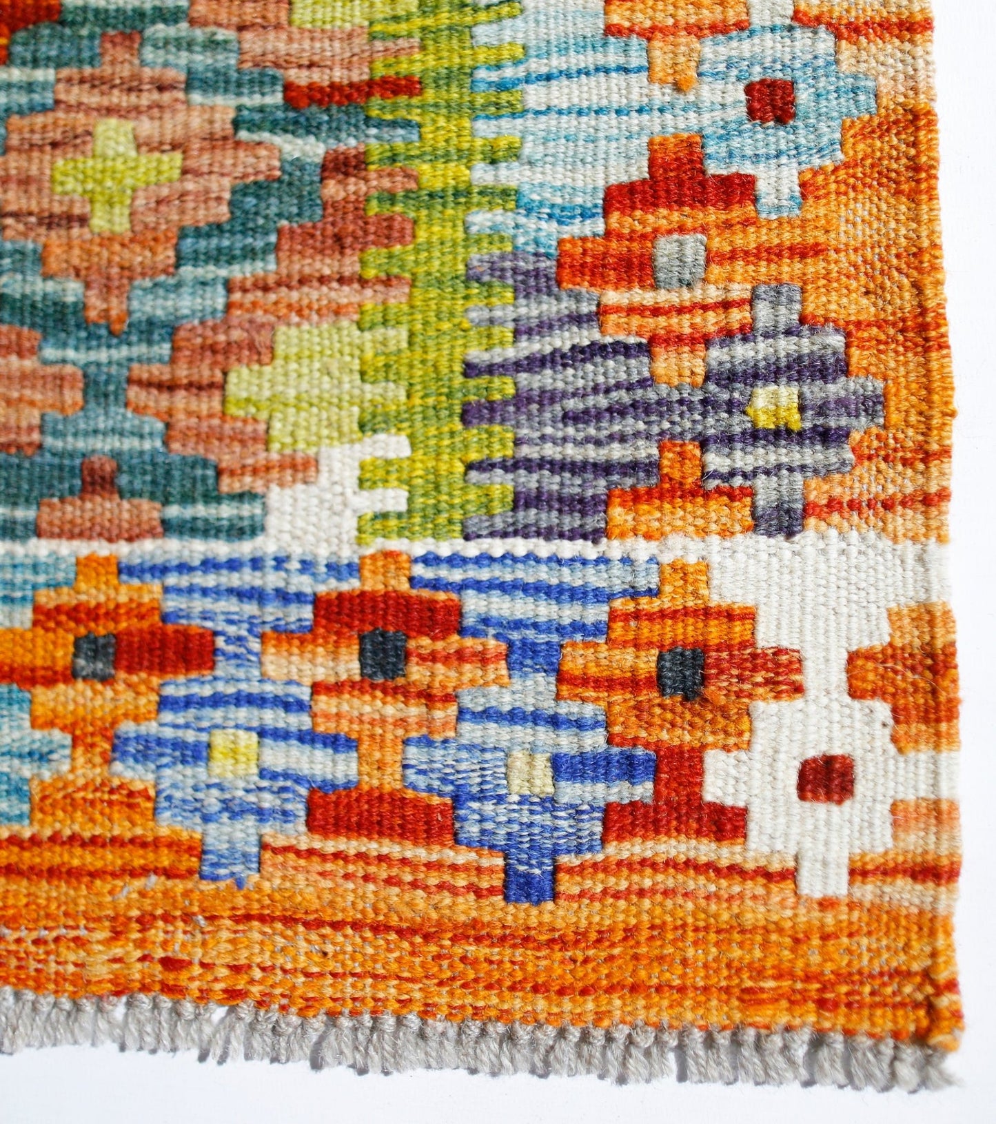 Handwoven Afghan Maimana kilim rug featuring a vibrant geometric pattern in wool.