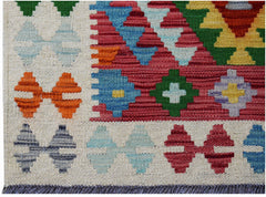 Handwoven Afghan Maimana kilim rug featuring a colorful geometric pattern on a cream background.