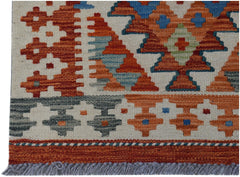 Handwoven Afghan Maimana kilim rug featuring geometric patterns in orange, blue, and grey wool.