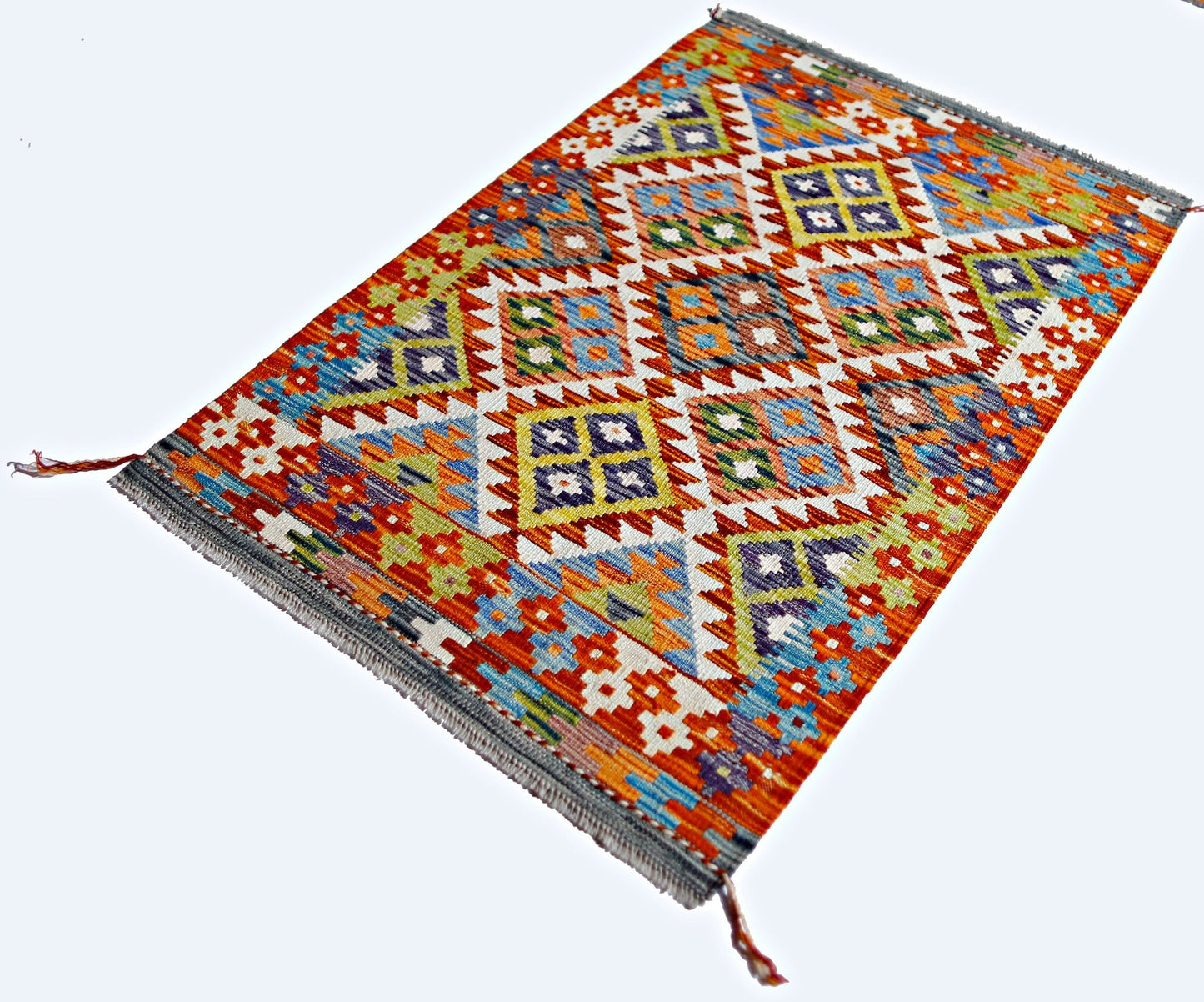 Handwoven Afghan Maimana kilim rug featuring a vibrant geometric pattern in wool.