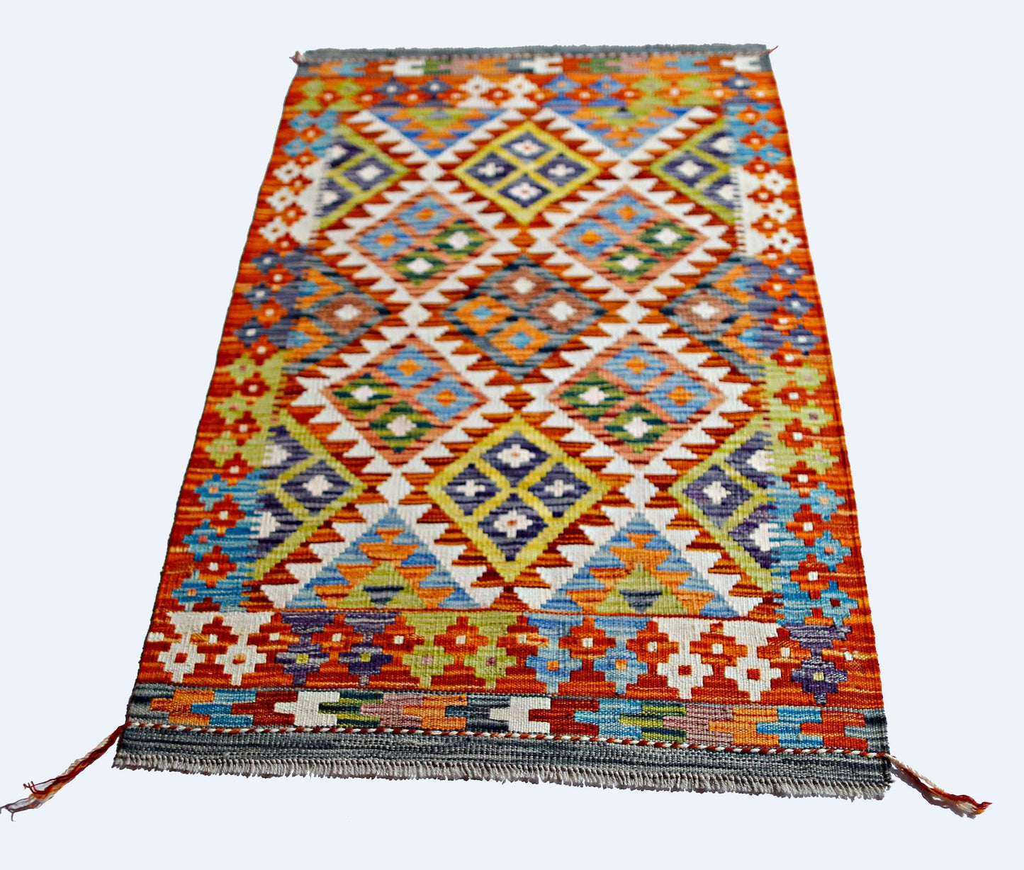 A rectangular Afghan Maimana kilim featuring a vibrant, multi-colored geometric diamond pattern.