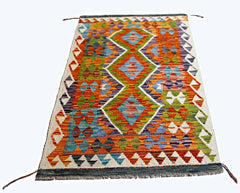 Handwoven Afghan Maimana kilim rug featuring a vibrant geometric diamond pattern in wool.