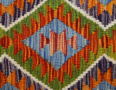 A handmade Afghan Maimana kilim featuring a vibrant geometric pattern in wool.