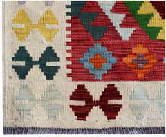 Handwoven Afghan Maimana kilim rug featuring a geometric pattern in vibrant, multi-colored wool.