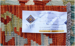 A hand-knotted Afghan Maimana kilim featuring a geometric pattern in shades of orange and blue.
