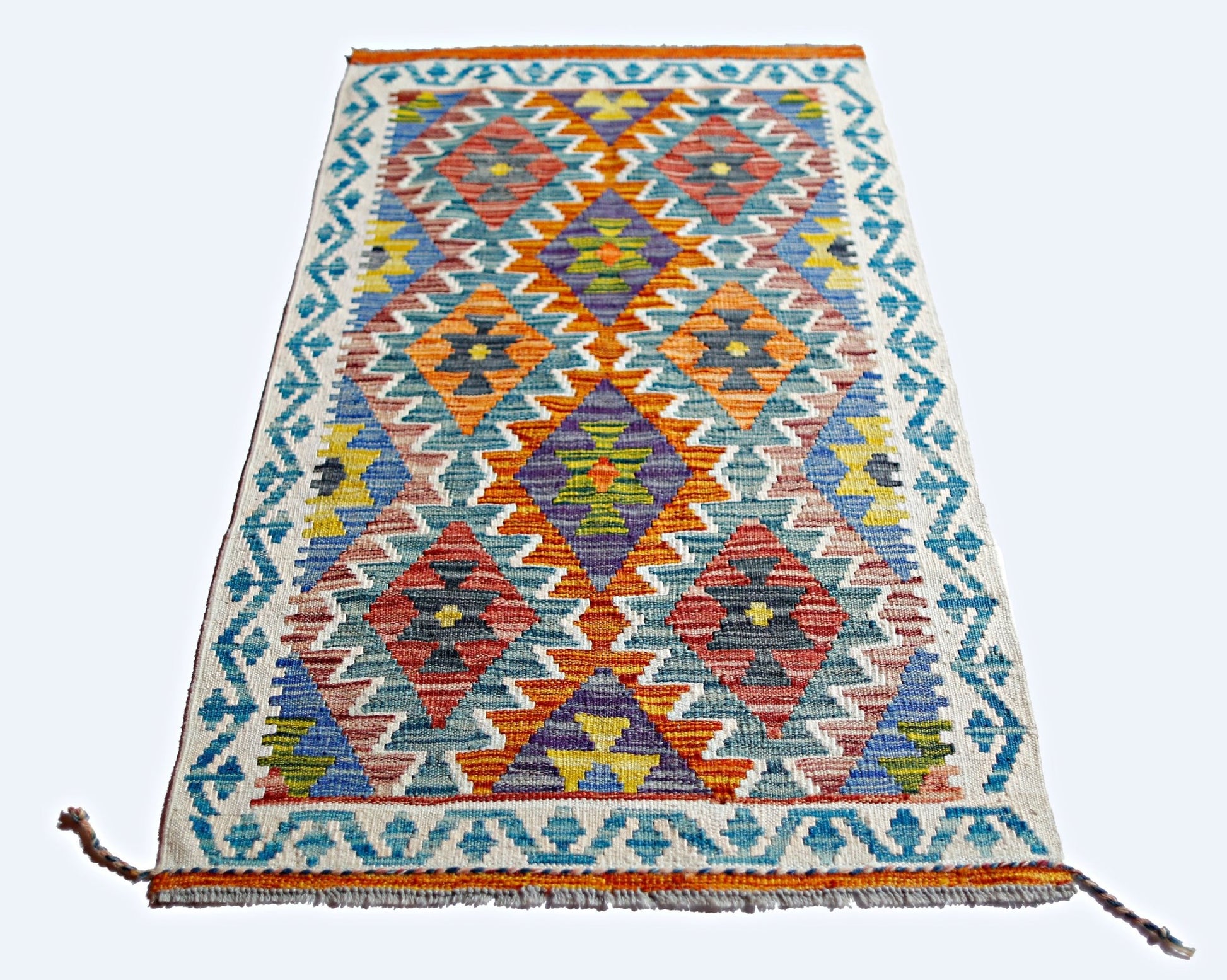 A rectangular Afghan Maimana kilim featuring a vibrant geometric diamond pattern in wool.