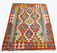 Handwoven Afghan Maimana kilim rug featuring a vibrant geometric diamond pattern in wool.