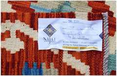 A handwoven Afghan Maimana kilim featuring a geometric pattern in shades of red, blue, and cream.