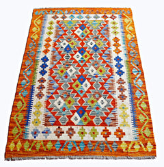 Handwoven Afghan Maimana kilim rug featuring a vibrant geometric pattern in wool.