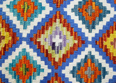 Handwoven Afghan Maimana kilim featuring a vibrant geometric diamond pattern in wool.
