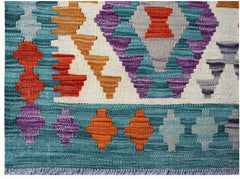 Handwoven Afghan Maimana kilim rug featuring a geometric pattern in vibrant multicolored wool.