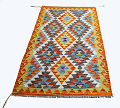 A rectangular handmade Afghan Maimana kilim featuring a vibrant geometric diamond pattern.