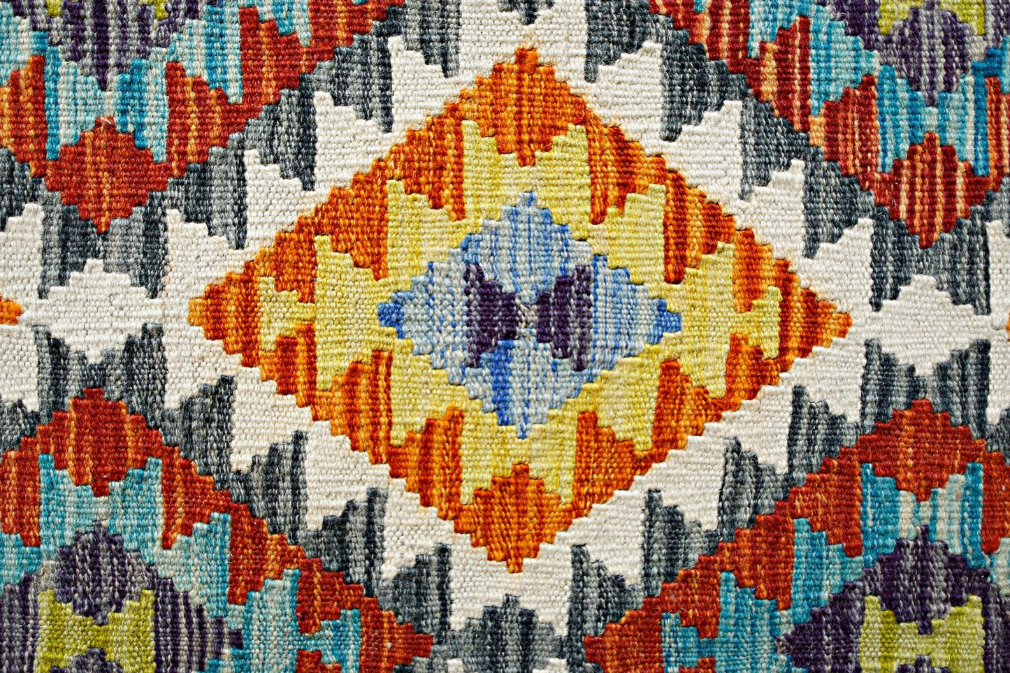 Handwoven Afghan Maimana kilim featuring a vibrant geometric diamond pattern in wool.