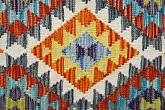 Handwoven Afghan Maimana kilim featuring a vibrant geometric diamond pattern in wool.