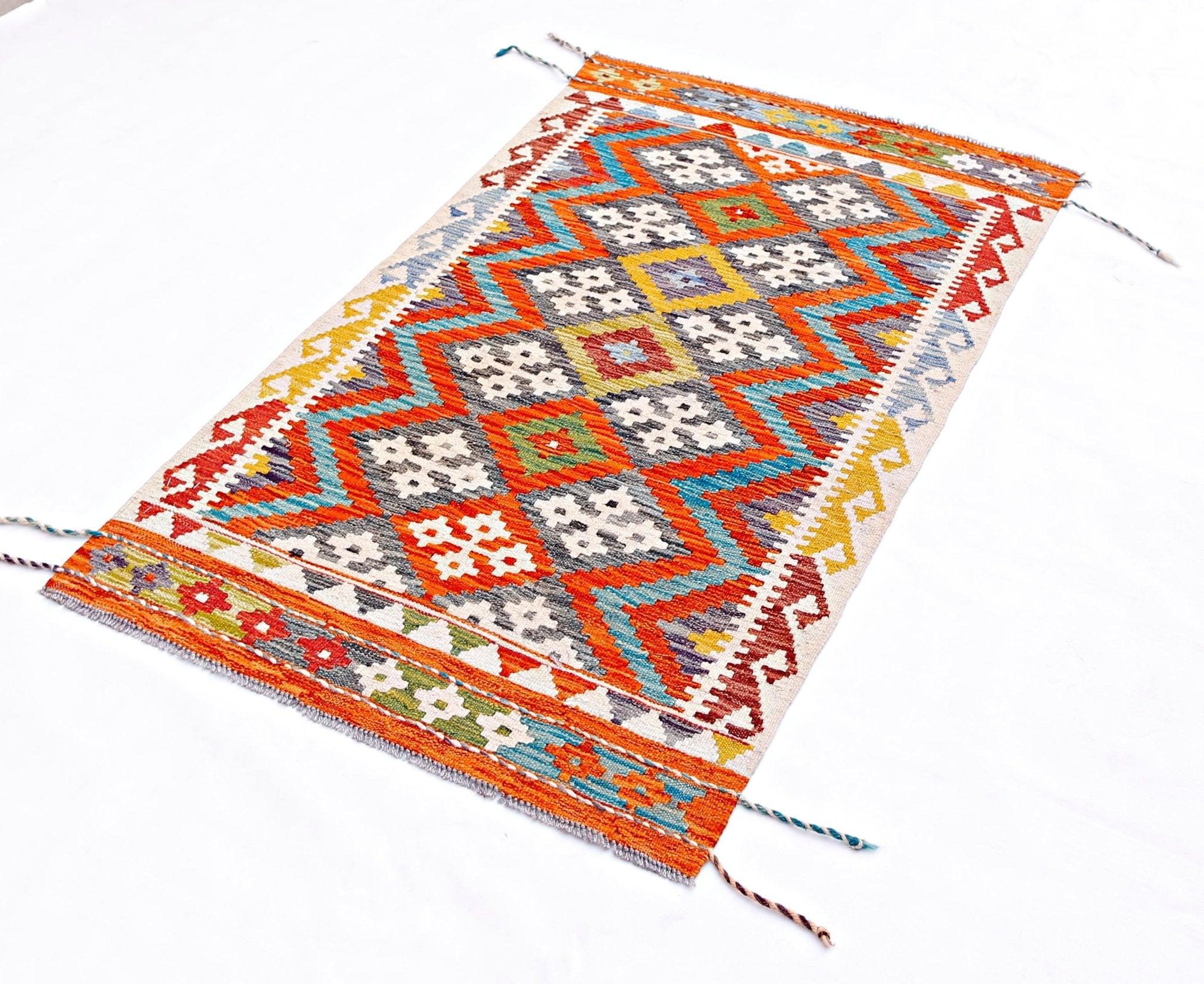 A rectangular handmade Afghan Maimana kilim featuring a vibrant geometric pattern in wool.