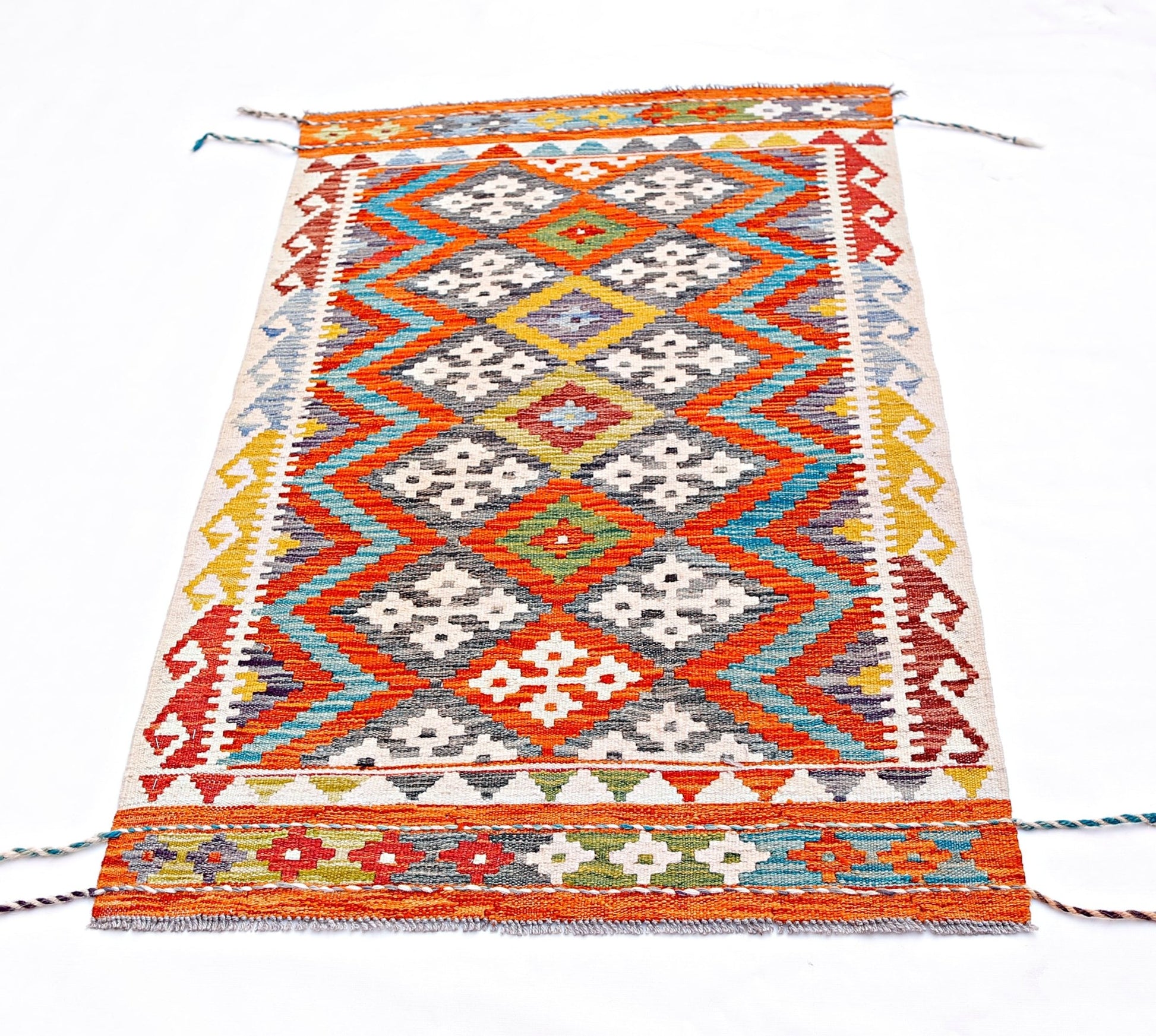 Handwoven Afghan Maimana kilim rug featuring a vibrant geometric diamond pattern in wool.