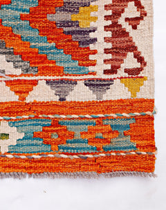 Handwoven Afghan Maimana kilim featuring geometric patterns in vibrant orange, blue, and yellow.