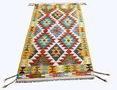 Handwoven Afghan Maimana kilim rug featuring a vibrant geometric pattern in wool.