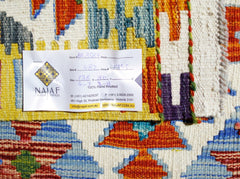 A handwoven Afghan Maimana kilim featuring a vibrant geometric pattern in wool.