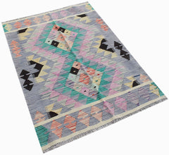 Handwoven Afghan Maimana kilim rug featuring a geometric pattern in pastel and dark tones.