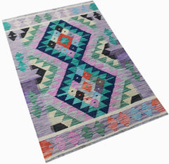 Handwoven Afghan Maimana kilim rug featuring a geometric diamond pattern in vibrant colors.