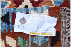 A handwoven Afghan Maimana kilim featuring a geometric pattern in blue, red, and cream wool.