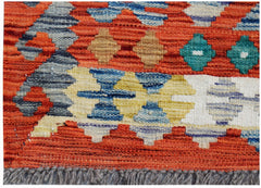A handwoven Afghan Maimana kilim rug featuring geometric patterns in vibrant orange and blue tones.