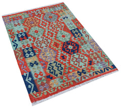 Handwoven Afghan Maimana kilim rug featuring a vibrant geometric pattern in wool.
