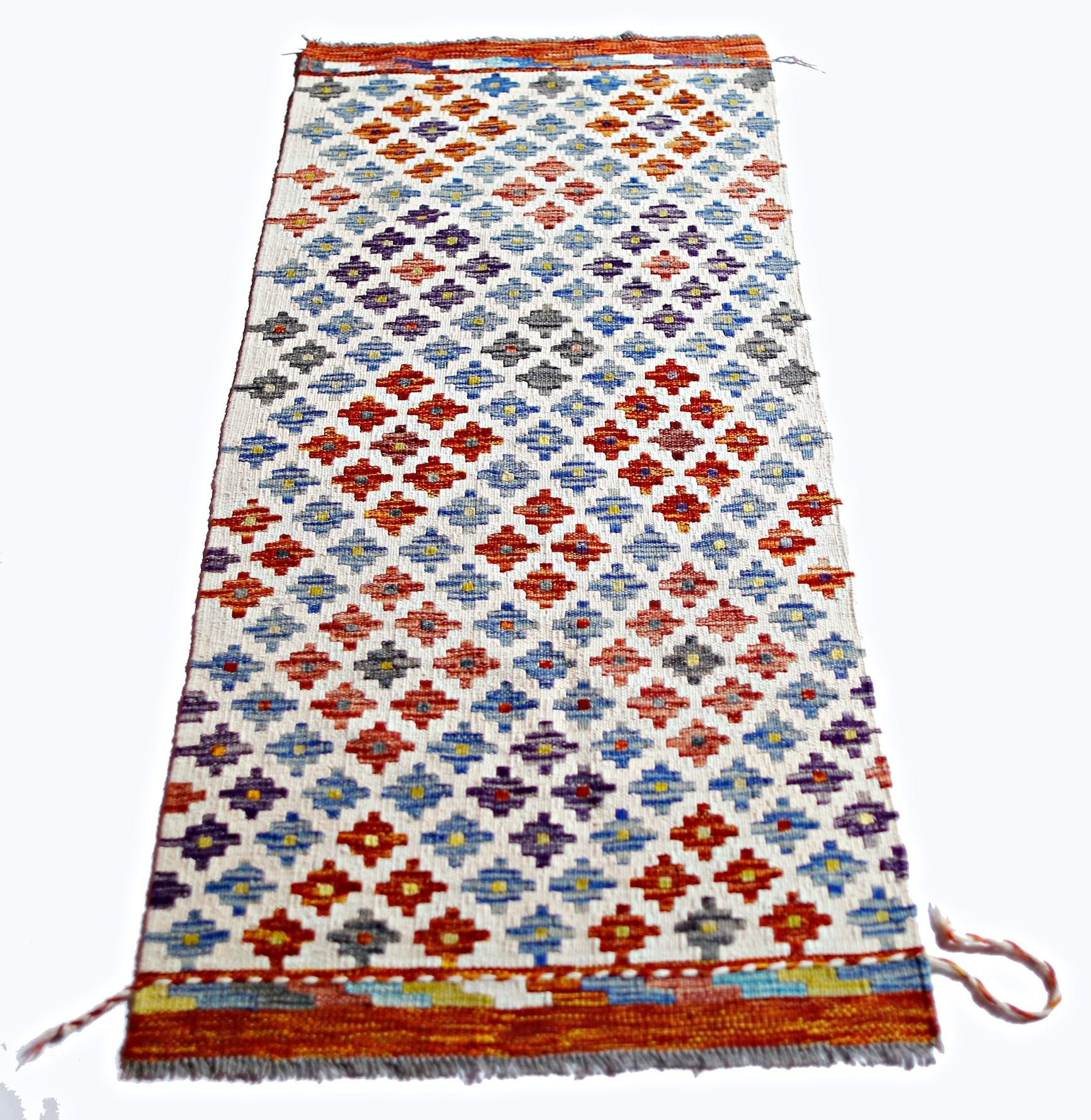 Handwoven Afghan Maimana kilim featuring a repeating geometric pattern in vibrant colors.