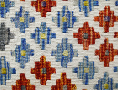 Handwoven Afghan Maimana kilim featuring a repeating geometric pattern in blue, red, and yellow.