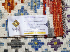 A handwoven Afghan Maimana Kilim featuring a geometric pattern in vibrant colors on a wool base.