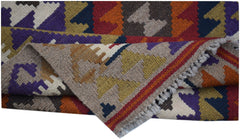 A handmade Afghan Maimana kilim rug featuring a colorful geometric pattern and flatweave texture.