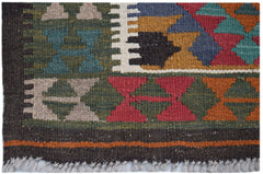 A handmade Afghan Maimana kilim rug featuring a geometric pattern in vibrant, multi-colored wool.