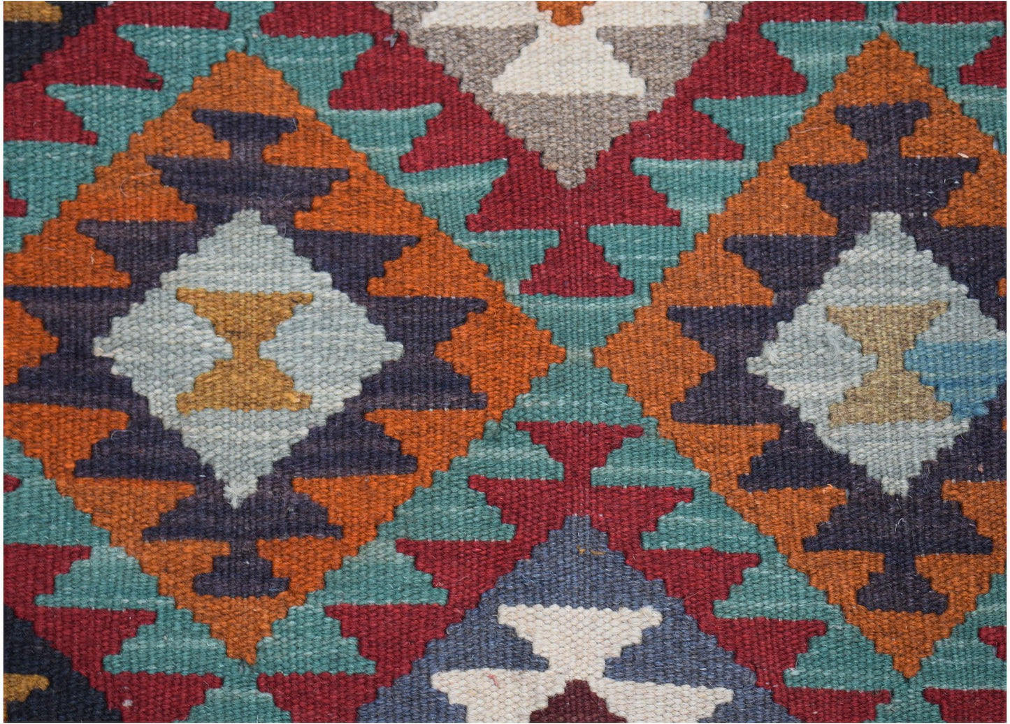 Handwoven Afghan Maimana kilim featuring a geometric diamond pattern in vibrant wool colors.