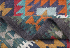 A handwoven Afghan Maimana kilim rug featuring a colorful geometric pattern in wool.