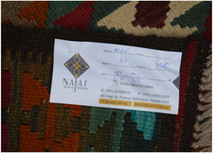 An Afghan Maimana kilim rug featuring a geometric pattern in rich, multicolored wool.