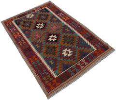 A rectangular Afghan Maimana kilim rug featuring a geometric pattern in rich, multicolored wool.