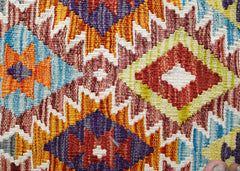 Handwoven Afghan Maimana kilim featuring a vibrant geometric pattern in wool.