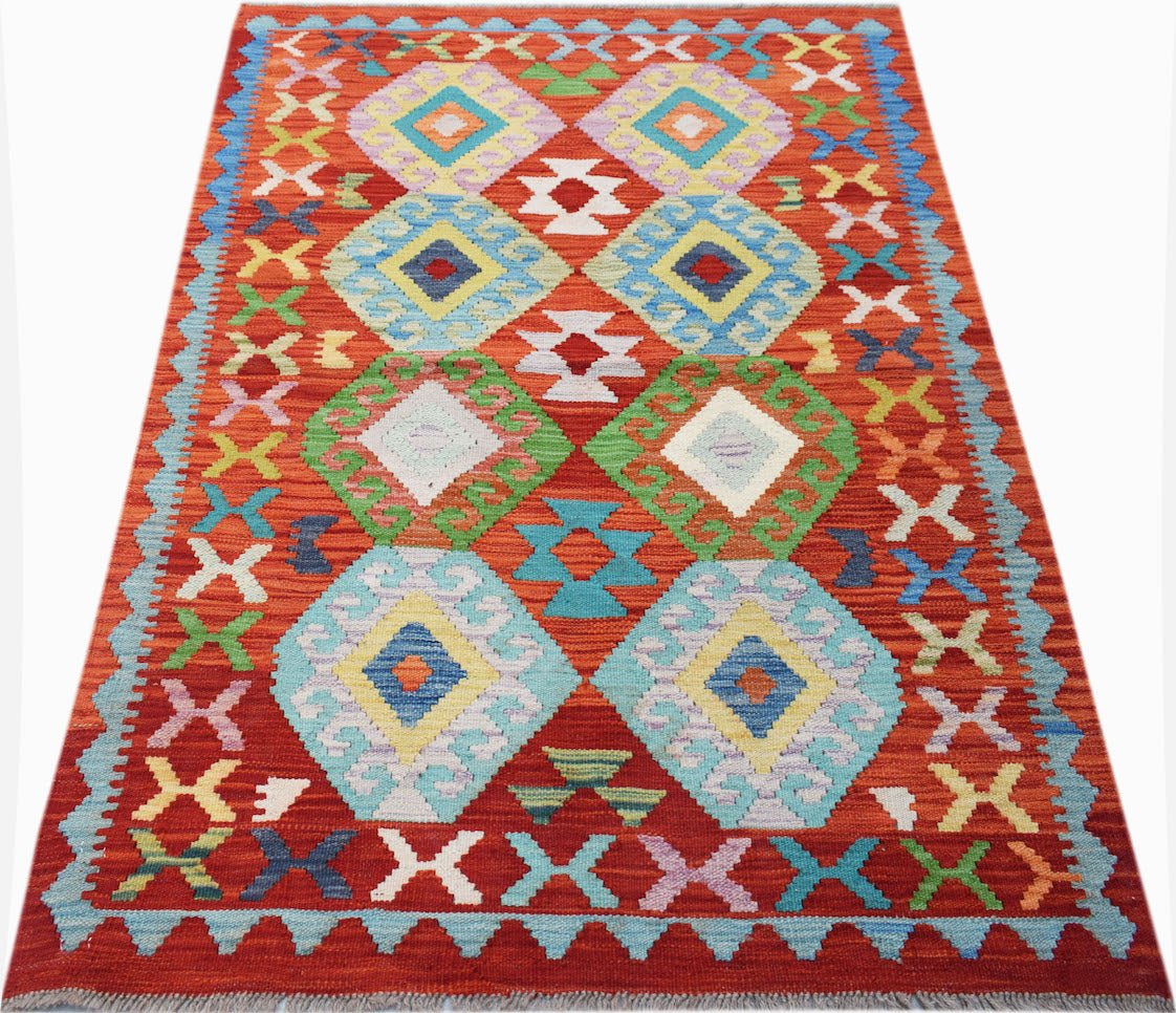 Handwoven Afghan Maimana kilim rug featuring a vibrant red background with colorful geometric motifs.