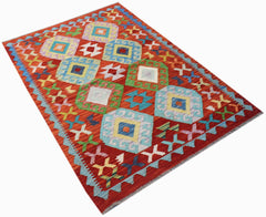 Handwoven Afghan Maimana kilim rug featuring a vibrant red background with geometric diamond motifs.