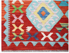 Handwoven Afghan Maimana kilim featuring a vibrant red background with geometric patterns.