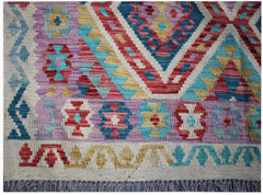 Handwoven Afghan Maimana kilim rug featuring a colorful geometric pattern on a flat wool weave.